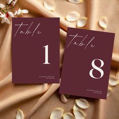 the table numbers are placed next to each other on top of a sheet of fabric