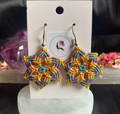 💚 Adorn yourself with the beauty of nature with our handmade Flower colourful macrame earrings. These unique accessories feature vibrant blooms intricately woven into macrame knots, creating a petal dance that adds a touch of boho chic to your style.  💚 This pair was handcrafted with love and care, bringing you the perfect blend of floral elegance and artisan craftsmanship. Make a statement with these Flower colourful macrame earrings, a celebration of nature's beauty. ✅ Features: ✔️ Unique de Traditional Macrame Earrings, Artisan Multicolor Macrame Jewelry, Artisan Adjustable Flower Earrings, Adjustable Bohemian Drop Flower Earrings, Multicolor Bohemian Nickel-free Flower Earrings, Handmade Artisan Dangle Flower Earrings, Artisan Handmade Dangle Flower Earrings, Adjustable Yellow Bohemian Earrings, Handmade Artisan Flower Drop Earrings