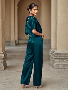 This soft satin jumpsuit features a flattering v-neck design, making it the perfect choice for mothers of the bride. Its dress pantsuit style provides comfort and elegance, while its high-quality material ensures a polished look. Stay stylish and comfortable on that special day with our jumpsuit. Formal Satin V-neck Jumpsuit, Elegant Satin Jumpsuit Or Romper In Solid Color, Elegant Satin Pantsuit For Evening, Elegant Satin Jumpsuits And Rompers For Workwear, Elegant Silk V-neck Jumpsuits And Rompers, Elegant Silk V-neck Jumpsuit, Elegant V-neck Evening Pantsuit, Satin V-neck Jumpsuits And Rompers For Party, Satin Jumpsuit With V-neck For Party