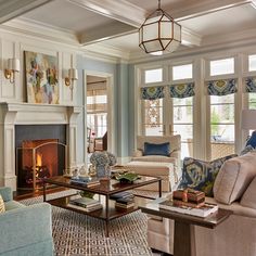 a living room filled with furniture and a fire place in the middle of a room