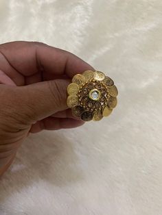 This beautiful peach-colored Kundan ring is perfect for adding a touch of elegance to any outfit. The ring features a stunning peach-colored main stone that is sure to catch the eye. Its intricate design and attention to detail make it a true work of art. Crafted with care and with an eye for detail, this ring is a must-have for any jewelry collection. Its timeless beauty is sure to endure, making it an excellent investment for any fashion-savvy individual. The ring is perfect for any occasion, Gold Pearl Ring With Metal Band, Gold Enamel Ring As Gift, Gold Enamel Ring Gift, Vintage Gold Enamel Ring For Wedding, Traditional Gold Enamel Ring For Gift, Traditional Gold Enamel Ring As Gift, Traditional Gold Enamel Ring Gift, Gold Crystal Ring For Marriage, Gold Enamel Open Ring For Wedding