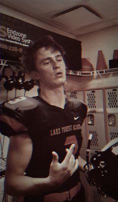 a young man wearing a black football uniform