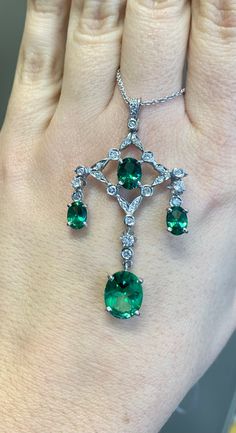 Metal: 14kt And 18kt White Gold Stone: Diamond And Green Topaz Stone Shapes: Round And Oval-shape Green Topaz Weight: 6.99 Carats Diamond Weight: .65 Carats Weight of entire piece with chain: 9.30 Grams Type of Chain: 14kt White Gold 2 mm Cable Chain Length Of Necklace: 18 Inches and can be cut shorter per your request. Type Of Closer: Lobster Clasp Length Of Pendant: 54mm Width Of Pendant: 30mm Exquisite Emerald Necklace For Anniversary, Elegant Brilliant Cut Emerald Gemstones, Gia Certified Elegant Emerald Gemstones, Elegant Gia Certified Emerald Gemstones, Briolette Emerald Necklace For Formal Occasions, Formal Emerald Briolette Necklace, Formal Briolette Emerald Necklace, Elegant Gia Certified Gemstones, Classic Hallmarked Emerald Necklace With Diamonds