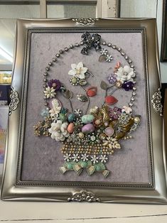 a silver frame holding a bunch of buttons and other things in it's center