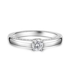 Simple and stunning, this ring showcases a magnificent round cut stone standing tall in the traditional four-prong setting, while additional round stones line the shank. So elegant it needs no further accompaniment, this ring is finished with a bright polished shine. The stones in this engagement ring shine brightly enough to be deserving as a symbol of your love.Carat Weight: 0.275 ctStone Size: 4 mmStone Type: Jeulia® StoneNumber of Stones: 1 Stone Color: Diamond WhiteStone Shape: RoundCarat Weight: 0.648 ctStone Size: 1.1,1.3,1.5 mmStone Type: Jeulia® StoneNumber of Stones: 32 Stone Color: Diamond WhiteStone Shape: RoundWeight: 2.7 gWidth: 1.7 mmHeight: 4.9 mmThickness: 1.2 mmMaterial: 925 SilverPlating Color: Silver Anniversary Sale, White Stone, Gemstone Colors, Diamond White, Sterling Silver Ring, Prong Setting, Wedding Rings Engagement, Round Cut, Stone Color