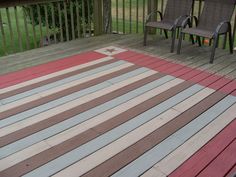 two chairs sitting on top of a wooden deck