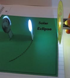 someone is cutting out a solar eclipse paper