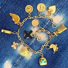 Vintage Charm Bracelet with a dozen nostalgic charms suspended from a 14k solid gold chain. Get 11 new charms all in one!! This bracelet was made with heart and soul and has the most personal touches. Each charm has its own distinct meaning, to remember cherished memories and adventures. NOTE: the Rabbit in a Hat Charm has been removed! Charm Collection: 1. "Paris" Hat Box 2. Broom 3. Baby Carriage 4. Enamel 3 Leaf Clover Bell 5. Sunbeam Heart 6. Butterfly 7. Whistle (It Works!) 8. Broken Heart Vintage Metal Charm Bracelet With Chain, Vintage Yellow Gold Charm Bracelet, Antique Charm Bracelet With Vintage Charm, Rabbit In A Hat, Paris Hat, 3 Leaf Clover, Luxury Gold Antique-style Charm Bracelet, Gold-tone Metal Charm Bracelet With Vintage Charm, Vintage Charm Bracelet