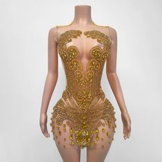 a mannequin with gold sequins on it's body and back