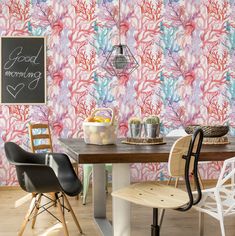 a dining room table with chairs and a chalkboard on the wall next to it