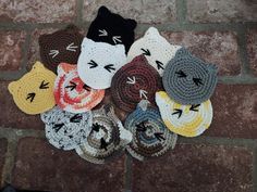 there are many crocheted hats on the brick floor next to eachother