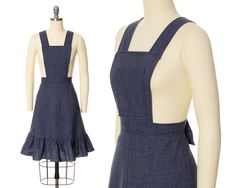 "♡ PLEASE ENLARGE PHOTOS FOR MORE DETAIL ♡ D E T A I L S * 1970s pinafore skirt * lightweight blue denim in a cotton (50%) - polyester (50%) blend * bib front * wide straps attach via buttons on back waist (two length settings) * fitted natural waist * a-line shape * ruffled tier at hem * nylon back zipper + button closure * unlined * label: size/content tag present M E A S U R E M E N T S fits like a: small bust: free bib width: 7.75\" (at top) bib length: 8.75\" waist: 27/27.5\" hips: free skirt length: 22.5\" skirt sweep: 49\" (just above ruffled tier) C O N D I T I O N Excellent vintage condition. No issues to note! Freshly cleaned and ready to wear! ➳ Please read store policies prior to purchase. Thank you!! xoxo, Allyson ♥ Visit the shop! http://www.birthdaylifevintage.etsy.com ♥ Fol Pinafore Skirt, Blue Denim Overalls, Prairie Dress, Womens Skirts, Denim Overalls, Overall Dress, Wide Straps, Small Bust, Vintage 1970s