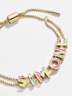 The brightest among our collection of Custom Slider Bracelets is our Multi Enamel style. This special bracelet features two strands of a box chain, an easily adjustable pull-tie closure, and vibrant gold and enamel beads. Choose a name, initials, or favorite phrase to customize your bracelet with - it's sure to be your new everyday staple. See our Letter Key for all options available. Preppy Accessories, Preppy Jewelry, Name Initials, Enamel Beads, Jewelry Accessories Ideas, Dope Jewelry, Gold Bead Bracelets, Jewelry Lookbook, Girly Jewelry