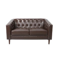 a brown leather couch sitting on top of a white floor