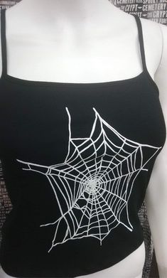 This is a black sleeveless Spiderwebs cropped tank top. This has a Spiderweb image screen printed on the front. 57% cotton/ 38% polyester/ 5% Spandex These are handmade screenprinted and slightly vary from the photo. Please feel free to email me any questions. Thanks for looking. Due to an influx of incorrect addresses if a package is returned, you must pay the shipping cost to resend the item to you. I do not do exchanges and I do not take returns unless the item is damaged. I thoroughly check Halloween Tank Tops, Black Summer Cosplay Top, Emo Black Top For Festival, Gothic Tank Top For Streetwear, Fitted Sleeveless Crop Top For Halloween, Black Punk Crop Top For Cosplay, Fitted Black Crop Top For Cosplay, Punk Sleeveless Cosplay Tops, Punk Sleeveless Tops For Cosplay