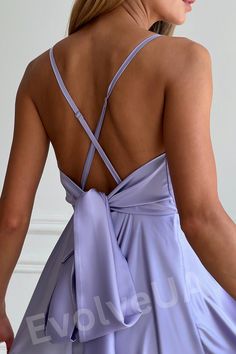 the back of a woman wearing a purple dress