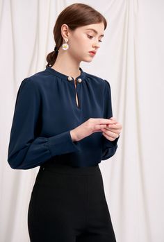 Everyone's favourite modern vintage style Buvette Pearl blouse now updated in a midnight-blue hue, featuring gently puffed sleeves, french cuffs and our signature pearl embellishment at the collar. Wear yours with a neutral coloured bottom and a bold red lip. Fabric: Soft, smooth and medium weight on the skin. Machine wash gentle (remove pearl) or hand wash. 100% Viscose. Fit Details: Relaxed fit. Fits true to size. Model measures 5'4", weighs 96 lbs and is wearing XS. Pearl Blouse, High Fashion Clothing, Modern Vintage Style, Bold Lip Color, Bold Lip, Bold Red Lips, Modern Vintage Fashion, High Fashion Outfits, Pearl Collection