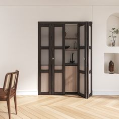 an empty room with a chair, table and bookcase on the floor in front of it