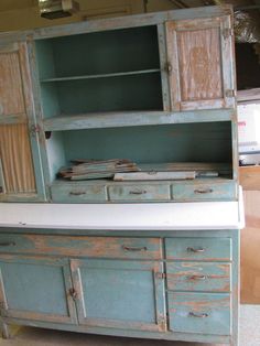 an old blue cabinet with white counter top