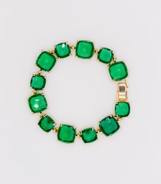 Introducing our "Emerald Elegance Gold-Plated Faux Diamond Bracelet" – a captivating jewelry piece designed to elevate your style quotient during the upcoming holiday season. This exquisite bracelet features a stunning array of vibrant green faux diamonds elegantly nestled within a lustrous gold-plated frame. Crafted with precision and artistry, the emerald green faux diamonds on this bracelet emulate the allure of genuine gemstones, providing a sophisticated and luxurious appearance. The intric Green Jeweled Bangle Bracelet, Glamorous Green Jewelry For Formal Occasions, Glamorous Green Jewelry, Green Emerald Bracelets For Party, Adjustable Green Jewelry For Holidays, Adjustable Green Jewelry For Holiday, Adjustable Bracelets For Holiday Party, Green Emerald Bracelets For Formal Events, Green Emerald Bracelets For Formal Occasions