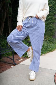 Step into effortless style with our Bayside Drawstring Bottoms, designed for the modern woman on the go. These lightweight, breathable pants offer a relaxed fit, perfect for casual outings or lounging in comfort. The adjustable drawstring waist ensures a perfect fit, while the vertical stripes elongate your silhouette, adding a touch of sophistication to your laid-back look. Pair them with a simple tee or dress them up with a chic blouse for versatile wear. These pants are an everyday essential Cotton Tapered Leg Bottoms For Vacation, Spring Relaxed Fit Bottoms With Drawstring, Relaxed Fit Drawstring Bottoms For Spring, Everyday Relaxed Fit Bottoms With Drawstring, Relaxed Fit Drawstring Bottoms For Everyday, Spring Casual Loungewear Bottoms, Relaxed Drawstring Bottoms, Relaxed Everyday Bottoms With Drawstring, Cotton Lounge Pants With Tie Waist