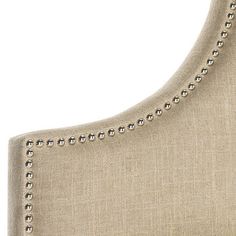 an upholstered headboard with studding and nail polishing on the back