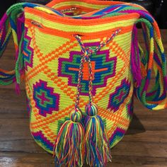 Each Bag Is Handmade In The Guajira By The Wayuu Tribe Takes 10-15 Hours And Is One Of A Kind Multicolor Woven Crossbody Bucket Bag, Casual Yellow Bucket Bag With Adjustable Strap, Traditional Multicolor Bucket Bag With Adjustable Strap, Casual Multicolor Woven Bags, Vibrant Multicolor Bags For Summer, Vibrant Beach Bags, Colorful Vibrant Travel Bags, Vibrant Multicolor Summer Bags, Vibrant Multicolor Rectangular Bags