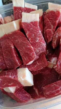 raw meat in a plastic container ready to be cut and put into the freezer