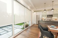 an open kitchen and dining room with sliding glass doors