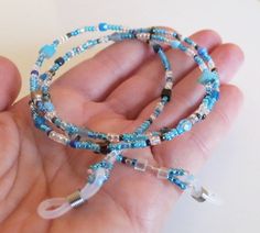 "Blue Beaded Eyeglass Chain,Christmas gift idea,Gifts for Mom,Aqua Glasses chain,Gifts for Her,Holiday Gift,Personalized Gift,Eyeglass holder ♥ All my items are made to each order, and are made in small series! Handmade beaded Eyeglass leash -in shades of aqua, blue, brown, crystal, made of tiny seed beads and a few small beads on wire - made to order. This item is the perfect gift to everyone wearing glasses! The item comes wrapped in a small organza bag - as pictured. Measures 27.6\" (70 cm) i Metal Beaded Glasses Chains As Gift, Beaded Glass Glasses Chains As Gift, Beaded Clear Glasses Chains As Gift, Beaded Clear Glasses Chains Perfect For Gifts, Gift Beaded Clear Glasses Chains, Blue Glasses Chains With Colorful Beads As Gift, Blue Glasses Chains With Colorful Beads For Gift, Blue Glasses Chain With Colorful Beads For Gift, Blue Glasses Chain With Colorful Beads As Gift