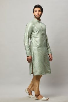 Brocade Kurta with gold embossing & placket plus gold churidar Crafted with a collar neckline, full sleeves, and front button closure. Occasion: Can be worn to lighter events like Sangeet, Mehendi, Puja, or a small party WASH CARE INSTRUCTIONS - Please Dry clean only when it is applicable. Slight color variation is possible due to digital photography. Traditional Fitted Kurta With Band Neckline, Pista Green Long Sleeve Kurta For Transitional Season, Pista Green Long Sleeve Kurta, Green Long Sleeve Sherwani For Transitional Season, Fitted Kurta With Zari Work And Stand Collar, Festive Green Long Sleeve Bandhgala, Wedding Long Sleeve Bandhgala With Zari Weaving, Wedding Bandhgala With Zari Weaving And Long Sleeves, Elegant Kurta With Band Neckline For Festive Occasions