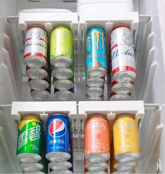 an open refrigerator filled with cans of soda