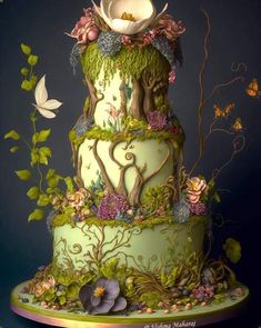 a three tiered cake decorated with flowers and vines