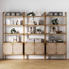 a wooden shelf filled with books and plants on top of a hard wood floor next to a white wall