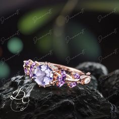 an image of a ring with purple stones on it