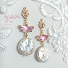 Looking for the perfect statement earrings for your wedding day? These Pearl Bridal Earrings with Pink Art Deco details are perfect for the boho bride who wants to add a touch of elegance to her look. With natural pearls and a long dangle design, these earrings are sure to make a statement on your big day.     They're also a great gift for bridesmaids or for any special occasion. MATERIALS: Brass gold plated 14k                        Pink Crystal faceted                        Clear Zircon AAA Handmade Pink Crystal Earrings For Wedding, Elegant Handmade Clip-on Earrings For Wedding, Elegant Handmade Clip-on Wedding Earrings, Pink Teardrop Pearl Earrings For Wedding, Pink Elegant Clip-on Earrings For Anniversary, Elegant Pink Clip-on Earrings For Anniversary, Handmade Wedding Clip-on Drop Earrings, Pink Pearl Drop Bridal Earrings For Wedding, Pink Round Chandelier Earrings For Wedding