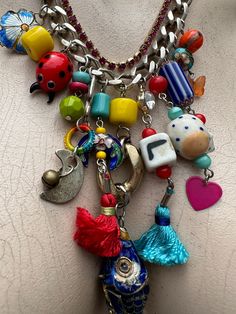 Fabulous hand created necklace!  Everything is intact . Charms include the letters L & I believe an E . There are 4 Cloissone parts including the fish, the rest are ceramic, fabric, plastic and a bit of bling in there also.  Fob fastener . Length is 47cm in total. Handmade Multicolor Unique Charm Necklaces, Handmade Unique Multicolor Charm Necklaces, Unique Multicolor Necklaces With Charms, One Of A Kind Multicolor Amulet Beaded Necklaces, Handmade Multicolor Charm Necklaces With Dangle, Multicolor Charm Necklace, Cheap Multicolor Fun Charm Necklaces, Handmade Multicolor Dangle Charm Necklaces, Unique Multicolor Charms Necklace