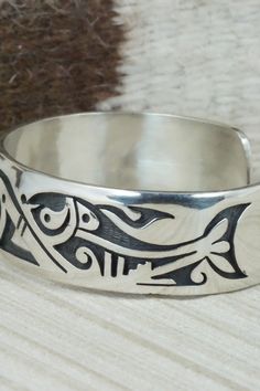 This sterling silver bracelet was made by Hopi silversmith Timothy Mowa. The inside is signed and stamped sterling.Size: 5 3/4" (will fit up to a 6 1/4" wrist)Gap: 3/4"Width: 3/4"Free shipping on all orders! We ship with USPS and always include tracking. All orders ship within a day of payment.Returns are accepted up to 30 days after you receive your order. Just send us a message. Our shop offers cash back or store credit. The item must be returned in new condition. Sterling Silver Bracelet, Native American Jewelry, Free Jewelry, Sterling Silver Bracelets, Cuff Bracelets, Silver Bracelet, Gap, Stamp, Bracelet