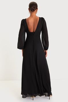 the back of a woman wearing a black dress with long sleeves and an open neckline