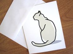 two white cards with a black outline of a cat sitting on top of each other