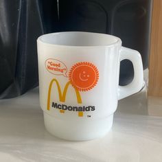 a mcdonald's coffee cup sitting on top of a counter