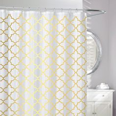 a white and yellow shower curtain in a bathroom