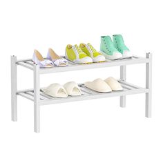 four pairs of shoes are lined up on a white shelf with two rows of them