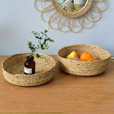 two wicker baskets sitting on top of a wooden table