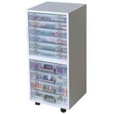 a white storage cabinet with lots of drawers on wheels and plastic bins in front of it