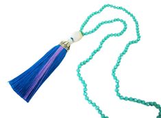 Colorful thick fabric tassel necklace designed in turquoise and a strip of pink.  It is attached to an all glass beaded necklace in light turquoise color glass beads and white stones above the tassel.  Fun to wear and works great as a casual or dressy piece!   Necklace length ~ Approximately 30 inches Tassel length ~ Approximately 4 inches long. Pull over necklace and no lobster claw. Blue Tassel Necklace For Gift, Blue Long Tassel Necklace, Turquoise Beaded Necklace With Tassels, Turquoise Beaded Necklace With Tassels And Round Beads, Blue Beaded Tassel Long Necklace, Blue Beaded Long Tassel Necklace, Blue Beaded Tassel Necklace For Festival, Adjustable Turquoise Tassel Necklace With Round Beads, Handmade Blue Adjustable Tassel Necklace