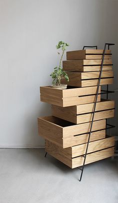 a stack of wooden drawers with plants in them