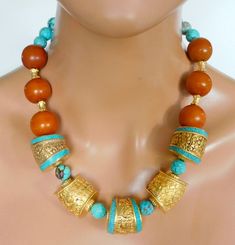 Magnificent handmade beads from Tibet and Moroccogold washed repousse brass beads, "plain" and with inlaid turquoise and handmade round **ber *es** Moroccan beads.  Natural Tibetan turquoise faceted round beads and handmade karat gold over brass fancy cylinder beads from Turkey complete this 1 of a kind stunning statement necklace.  I have shown pics of necklace on mannequin with necklace fastened at shortest length and at longest length.  You can adjust length to fit neckline of garment you are wearing. Necklace fastens with my large handmade signature brass clasp and GP handmade brass chain.  Length adjust from about 19 - 21 inches. Artisan Beaded Turquoise Necklace For Festivals, Turquoise Jewelry With Round Wooden Beads, Traditional Turquoise Wooden Beads, Festival Turquoise Beaded Necklaces, Handmade Turquoise Beaded Necklace For Festivals, Turquoise Necklace With Wooden Round Beads, Turquoise Necklace With Wooden Beads, Turquoise Necklace With Round Wooden Beads, Turquoise Necklaces With Round Wooden Beads