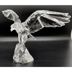 a crystal bird figurine sitting on top of a table