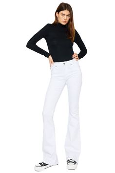 Our Alaska Mid Rise Jeans come in a classic flare cut in an opulent white color that was made to stand out. Sits right at the natural waistline as it gently tapers down the leg and begins to flare out at the calf. Made with super-stretch denim that keeps you feeling comfortable all day and won't bag out after each wear. Features a classic five-pocket design, single-button front, and zip-fly closure. 9" Rise   / 33.75" Inseam 66.5% Cotton, 31.3% Rayon, 2.2% Spandex Model in size 3/25 Style # : KC Classic White Flare Bottoms, White Stretch Flare Jeans, Elegant White Flare Jeans For Spring, Chic Fitted White Flares, Chic White Fitted Flares, Elegant White Wide Leg Flare Jeans, Elegant White Wide-leg Flare Jeans, White Flare Fitted Jeans, Chic White Flare Jeans For Fall